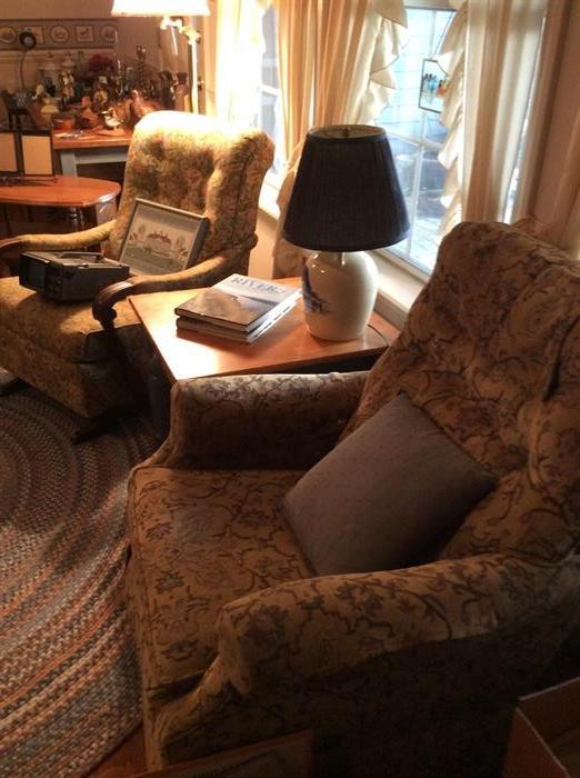 Antique upholstered rocker on left, newer casual chair on right.