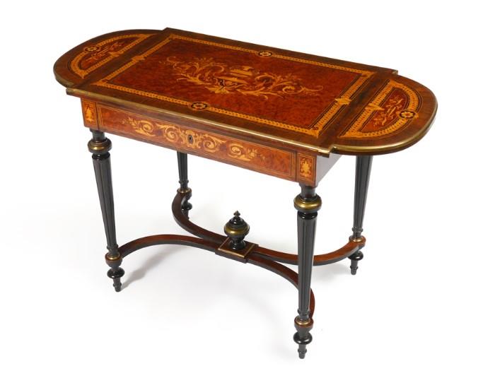 Lot 1004:  19TH C LOUIS XVI STYLE LADIES INLAID WRITING DESK: Double drop leaf desk of figural burl and marquetry inlays of tulip and satinwoods, Ca 1860. Single drawer with key. Curved stretcher joins reeded legs with gilding. Measures approx. 30''h. x 30''. x 21'', the extended leaves will add 16'' to the length.