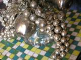 Detail of crackled silvered glass & metal floral & fruit arrangement.