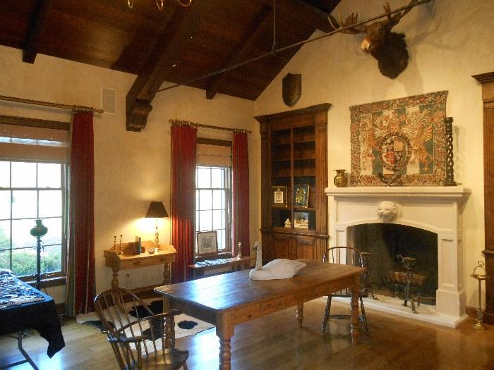Great Room:  Pine harvest table with two drawers (7 feet 1 inch x 35-l/2 inches tall); two 1800's Windsor arm chairs; pine furniture; antique andirons; wooden swan; antique floor lamp; and more! On the mantel to the right is a 36" antique barley twist candleholder.  Note:  BULLWINKLE is not for sale.