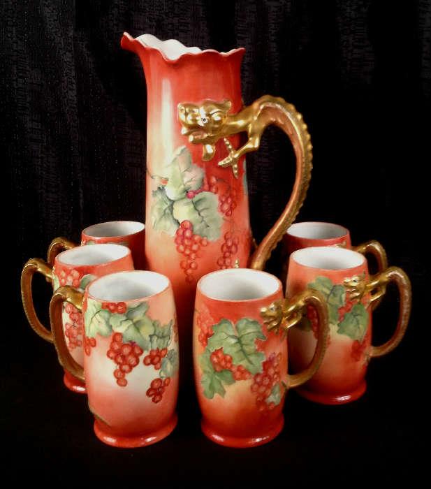 1155 - Seven piece dragon handle tankard set with matching mugs, signed Limoges, 15IN T, 9IN H-S