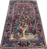 Lot#3001, KERMAN SOUTH CENTRAL IRAN HAND WOVEN PRAYER RUG, C. 1920, W 4' 4" L 7' 3"Decorated with a central tree form, with birds, deer, and scrolling floral designs on a dark blue ground, featuring a multitude of accent colors. Measuring L. 7 ft. 3 x 4 ft. 4. Circa 1920.