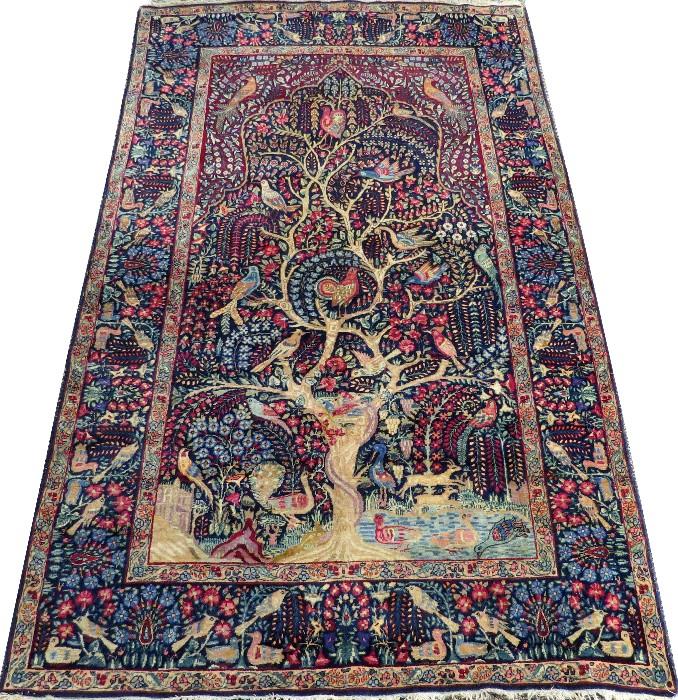 Lot#3001, KERMAN SOUTH CENTRAL IRAN HAND WOVEN PRAYER RUG, C. 1920, W 4' 4" L 7' 3"Decorated with a central tree form, with birds, deer, and scrolling floral designs on a dark blue ground, featuring a multitude of accent colors. Measuring L. 7 ft. 3 x 4 ft. 4. Circa 1920.