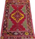 Lot#3135, TURKISH HAND WOVEN RUG, C. 1890, W 3' 7" L 5' 3"Featuring a center diamond form medallion on a red ground, decorated with geometric designs about the border in green, red, and puce. Measuring L. 5 ft. 3 x 3 ft. 7. Circa 1890.