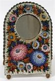 Lot#21, ITALIAN MICRO-MOSAIC, EASEL BACK PICTURE FRAME, H 7 1/4", W 5"Arched form easel back picture frame, decorated in all over micromosaic floral motif on a white ground. Measuring H. 7 1/4" x 5", opening measures Dia. 2 3/8".