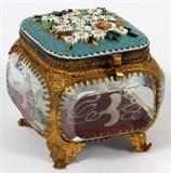 Lot#29, ITALIAN MICRO MOSAIC & ETCHED GLASS DRESSER BOX, H 2 1/2"Square form footed box, fitted with four glass panels in a gilt metal frame, decorated with a micro mosaic of daisies on a blue ground at the hinged lid. Measuring H. 2 1/2" x 3" x 2 1/2".