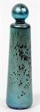Lot#80, MARK PEISER ART GLASS PERFUME BOTTLE, 1977, H 4"Cylindrical slightly tapered form glass perfume bottle by Mark Peiser, decorated in a blue to green iridescent sheen, dated 1977. Measuring H. 4 1/2".