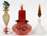Lot#89, CONTEMPORARY ART GLASS PERFUME BOTTLES, 1980-94, 3 PCS//Including one by Robert Levin [American, b. 1948] art glass bottle, dated 1980, featuring a Habatat Galleries label at the underside, at H. 6" x 3 1/2", together with one frosted glass bottle by Ellie Burke, dated '91, at H. 6", and one bottle by Ram, with frog form at the stopper, at H. 6 1/2".