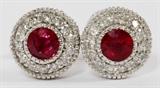 Lot#108, 0.92CT NATURAL RUBY & DIAMOND LADY'S EARRINGS, PAIR, DIA 1/4"14kt white gold stud back lady's earrings, each featuring a round natural red ruby, bezel set at the center, measuring 0.92 carats in total weight, surrounded by 0.86 carats of round side diamonds. Measuring Dia. 1/4", with a total approximate weight of 2.6 grams.
