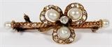 Lot#130, ANTIQUE 0.60CT DIAMOND & PEARL LADY'S PIN, L 1 1/2"10kt gold lady's pin, featuring a center prong set diamond, with surrounding round side diamonds along the petal like settings, accented with five pearls. The pin measures L. 1 1/2", with a total approximate weight of 4.4 grams.