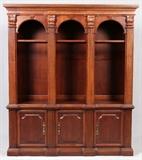 Lot#144, HOOKER FURNITURE, 3 SECTION BOOKCASE, LATE 20TH C., H 83", L 71", D 16"Fitted with three open shelf sections, each flanked by fluted column-like forms, above three doors, measuring H. 83 1/4" x 71" x 16". Later 20th Century.