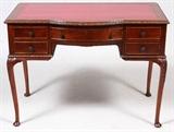 Lot#146, QUEEN ANNE STYLE MAHOGANY & LEATHER TOP DESK, H 28", L 39"Raised on carved cabriole legs with pad feet. Fitted with five drawers, having an inset tooled red leather top. Measuring H. 28 1/2" x 39" x 20 1/2".