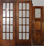 Lot#157, OAK AND BEVELED GLASS PANEL DOORS0 +TUG BOAT DOOR, 3 PIECES//includes two framed glass doors, 84"x 30", each with fifteen individual bevel glass panes, (one cracked). One panel has a brass door knob and mounting bezel. Oak glass paneled tug boat door, 73" x 22 1/4".