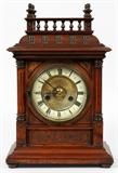 Lot#159, H.A.C., WURTTEMBERG, OAK MANTEL CLOCK, C. 1890, H 15", W 10"Oak case, 14 day strike mantel clock by the Hamburg American Clock Company, Wurttemberg. Featuring a 2 key wind dial, with Roman numerals. Circa 1890. Measuring H. 15 1/2" x 10". Eurich Clock World label at the interior. With keys