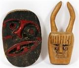 Lot#353, AFRICAN WOOD CARVED BORNEO MASKS, 2 PCS/one having a skewed face painted black with red highlights. The other of a blonde wood with horns and multiple eye holes.