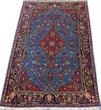 Lot#3025, KASHAN HAND WOVEN RUG, C. 1920, W 4' 4" L 6' 8"On a cerulean ground, having orange, red, and blue accents, with a central medallion. Measuring L. 6 ft. 8 x 4 ft. 4. Circa 1920.