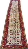 Lot#3156, CAUCASIAN MOGHAN HAND WOVEN RUNNER, C. 1870, W 3' L 11' 5"Decorated with all over repetitious floral motif, featuring animal figures about the sides, all on an ivory ground with a red border. Measuring L. 11 ft. 5 x 3 ft. Circa 1870.