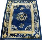 Lot#3181, CHINESE PEKING HAND WOVEN RUG, C. 1890, W 2' 9" L 3' 5"Featuring foliate designs on a blue ground with ivory accents. Measuring L. 3 ft. 5 x 2 ft. 9. Circa 1890.