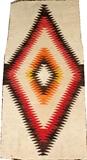 Lot#1326, NAVAJO WOOL RUG, C. 1900, 3' 3" X 1' 6"A dazzler style diamond at the center, in shades of red, orange, yellow, brown and black.