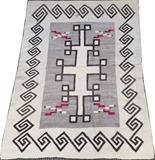 Lot#1332, NAVAJO RUG, C. 1890, 4' 11" X 3' 9"Geometric designs in grey and tan with red accents. Measuring L. 4 ft. 11 x 3 ft. 9. Circa 1890.