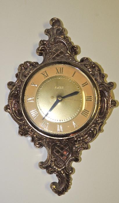 Brass clock (one of two identical).