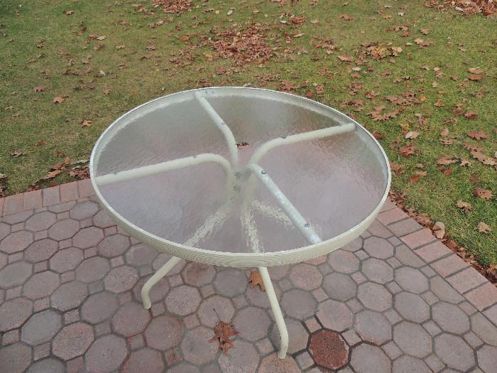 Round glass top table from patio set.