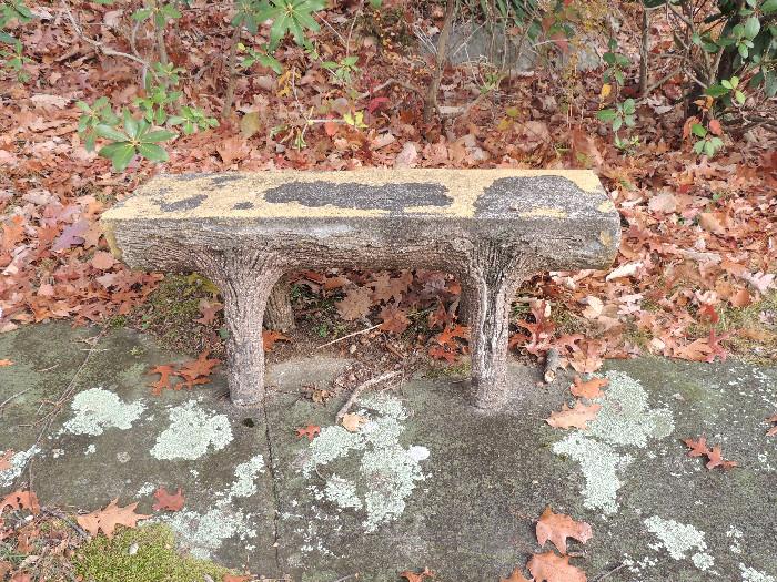 Cement garden bench in tree trunk form.