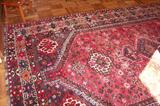 Beautiful oriental rug - in the sports room. Rug measures 6' 10" by 10' 4 1/2". It is in excellent condition and is an antique rug.