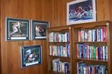 Daniel Moore print on top of bookcases - 3 of 4 wonderfully framed prints of baseball players in their various positions- located in the 'sports' room.