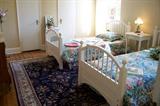 Pair of modern painted twin beds - which double as bunk beds. The ladder is not shown. Handmade oriental rug is on the floor. The rug measures 5' 9 1/2" by 9' 2".