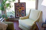 Wonderful lime green sofa and chair - lots of modern prints and paintings - located in the run room off of the living room.