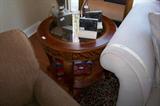 This is one of a pair of nice endtables - glass inset on top with carving on the legs. Each table has a shelf on the base.