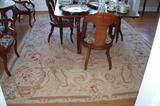 The dining room - with a set of 6 mahogany chairs, dining room drop leaf table, on a beautiful Aubusson rug. The Aubusson rug measures 8'8" by 11' 11". It is in beautiful condition.
