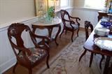 Closer view of the pretty dining room chairs and the marble top console table.
