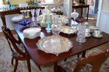 Silverplate, crystal, dessert sets - all on the dining room table.