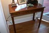 Nice walnut 2 drawer table in the living room.
