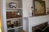 Beautifl leather books in the bookcases in the living room.