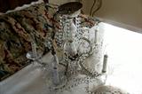 Beautiful crystal chandelier - on the bed in the bedroom.