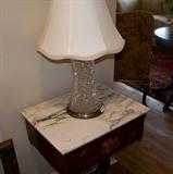 Cut glass lamp on the marble top table, leading into the living room.