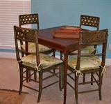Bamboo style card/game table with 4 chairs. The chairs are wooden, with cane seats (some seats damaged -thus the upholstered cushions)