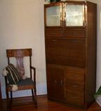 This is a wonderful piece - purchased in California years ago. It is a deco kitchen cupboard with enamel pull down door to reveal a bar. The bar/cabinet is in excellent condition.