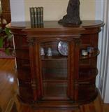 Beautiful cabinet - mahogany, with glass front, side shelves, and two beautiful columns on the front. This is an antique cabinet.
