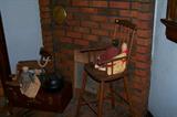 WOnderful antique child's high chair in the room off of the dining room.