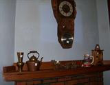 This picture shows the mantle in the room off of the dining room and the bottom of the hand carved clock.