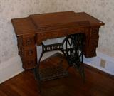 Antique Singer sewing machine on iron base.