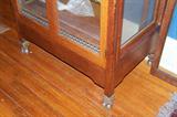 This cabinet has wonderful large brass caps/castors on each of the legs for easy rolling.