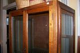 This is a great piece - would make a great shop/store piece. It is made of American oak - it is a pastry cabinet - it has glass on all sides - the side panels slide down to allow entry. The doors on front and back open for access from any direction. There are several metal shelves that fit inside the piece.