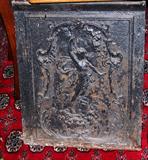 This is a beautiful old iron fireplace cover.