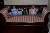 Antique Empire sofa- needs to have the springs re-adjusted. Otherwise in very nice condition. Located on the sofa are beautiful porcelain dolls.