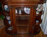 Beautiful plates, music boxes, covered boxes in the Victorian style china/buffet in the living room.